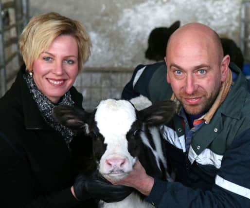 Husband and wife team Ruth and Ian Pollock pictured with one of their young calves on their farm outside Castlerock.