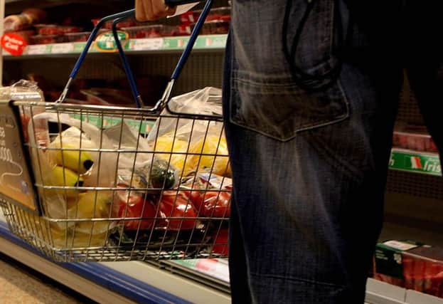 File photo dated 22/07/09 of someone shopping in supermarket, as the cost of a basket of groceries has fallen again as the supermarket price war overcomes inflation issues caused by the weaker pound, figures show. PRESS ASSOCIATION Photo. Issue date: Tuesday October 4, 2016. A basket of 35 popular items cost 16p less last month than it did in August, at Â£83.19, and is more than 3%, or Â£2.74, cheaper than it was at the same time last year, according to the mySupermarket Groceries Tracker. See PA story CONSUMER Groceries. Photo credit should read: Julien Behal/PA Wire
