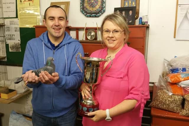 W and N Gilbert from Ballymena & Dist with the new Len Russell Cup presented at the INFC Charity Show for the first time last month for winning Old Bird Eye-sign. Willy is holding the winning bird