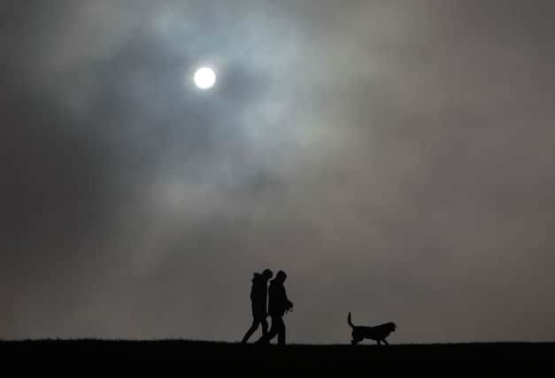 Dog walkers on the Dunstable Downs in Bedfordshire, as snow flurries and plunging temperatures were set to threaten Thursday's commute with large parts of the country covered by warnings of ice. PRESS ASSOCIATION Photo. Picture date: Thursday February 18, 2016. A wet Wednesday gave way to clearing skies overnight, bringing freezing conditions ideal for a hard frost and icy patches, with motorists and commuters urged to take care when they get on the move. See PA story WEATHER Ice. Photo credit should read: Steve Parsons/PA Wire