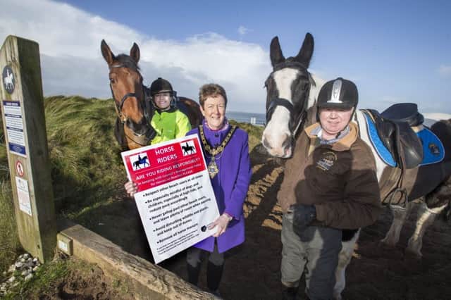 The Mayor of Causeway Coast and Glens Borough Council, Councillor Joan Baird OBE, helps to launch the beach safety awareness campaign with Julie Smyth and Philip White from Maddybenny Riding School, and their horses Humprey and Presley.Pic Steven McAuley/McAuley Multimedia