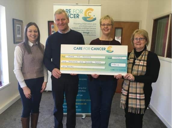 Ruth McKelvey, Mid Tyrone UFU Group Manager, Kenny and Jennifer Hawkes, Mid Tyrone representatives presenting Laura Mills, Care for Cancer with Â£1,136