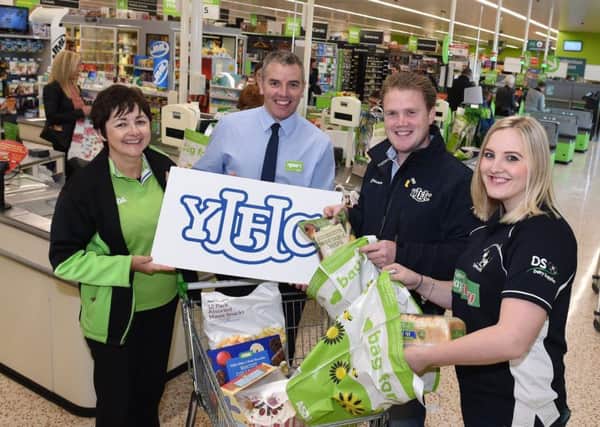 From left, Janice Gibson, ASDA peoples champion, Joe McDonald, corporate affairs manager ASDA, with James Speers, YFCU President, and Victoria Ross, Young Farmers member ready to do a bag pack.