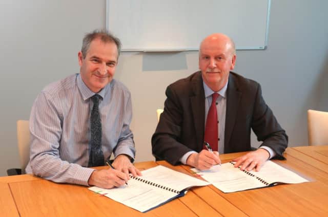 David Small of the Northern Ireland Environment Agency and Stan Brown of Forensic Science Northern Ireland sign a Memorandum of Understanding. It heralds a new partnership between the organisations as they track down the criminals who threaten the environment by dumping illegally.