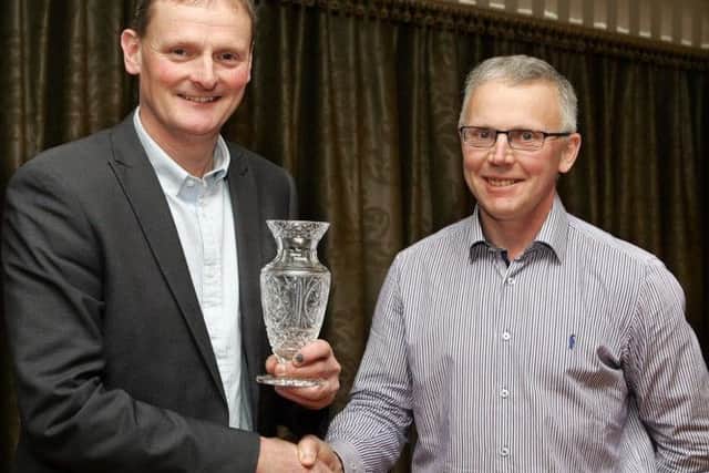 Fermanagh Grassland Club member, David Brown (left) winner of the club's Houston Trophy, being congratulated by club chairman John Egerton.