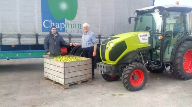 Mr Harold Chapma, of Chapman Foods, pictured  receiving the keys to his New Claas Nexos 210 VL - the first orchard tractor to be sold in Co. Armagh.