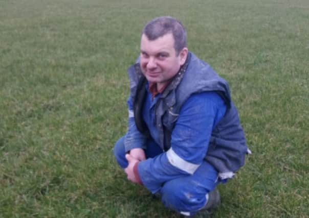 Mark Hamilton assesses ground conditions before sowing fertiliser