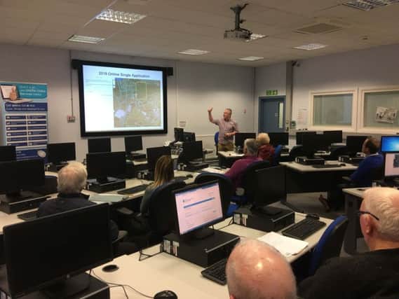 DAERAs Desmond Roulstone assists farmers with their online Single Application during a workshop at Enniskillen Agriculture Campus.
