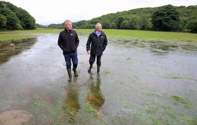 UFU leaders Barclay Bell and Ivor Ferguson looking at some of the flooded fields on farms in the Sperrins. Picture: Cliff Donaldson