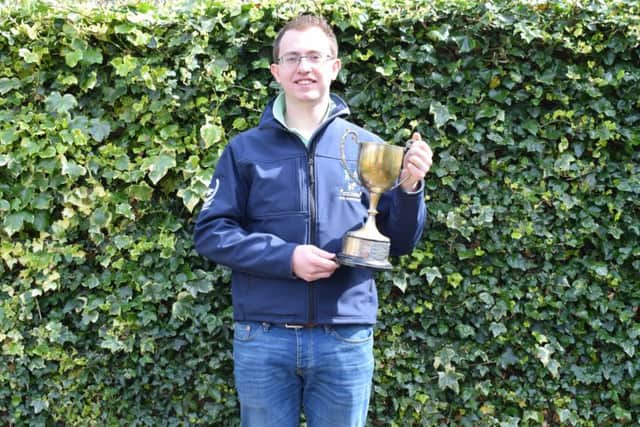 Winner of the Ulster Young Farmer, best under 21, sponsored by Danske Bank, is Andrew Reid, Crumlin YFC. Andrew is pictured picking up the Golden Plough Trophy