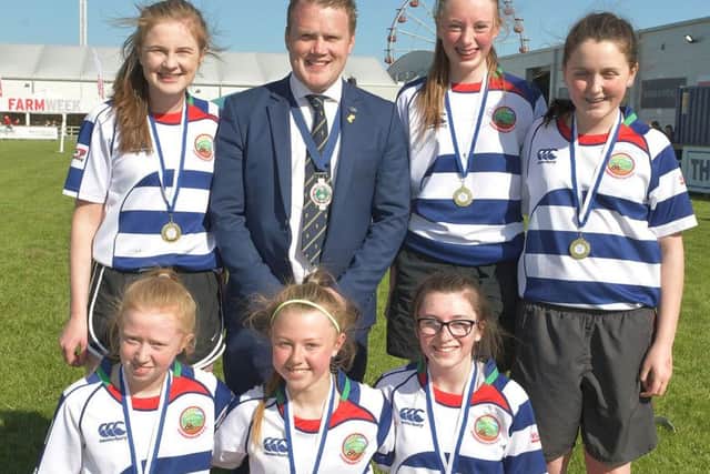 Pictured are team members from Lisnamurrican YFC 1 who were crowned junior champions at the YFCUs ladies football final held at the Balmoral Show 2018. Congratulating the girls on their achievement is YFCU president James Speers