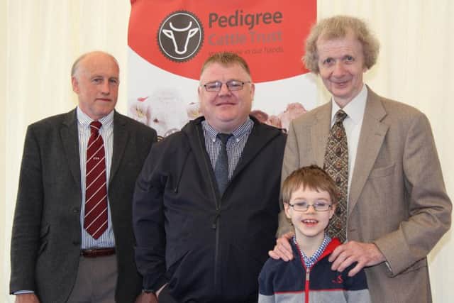 Pedigree Cattle Trust chairman Brian Walker, right, and grandson Charlie Cairns, are pictured at the 150th Balmoral Show with William Taylor, Farmers' for Action; and Sinn Fein MLA Declan McAleer.