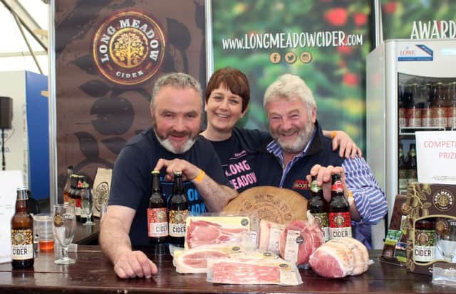 Partnership approach: Long Meadow Cider and Kennedy Bacon
from Omagh are teaming up to provide Hog Roast with cider basting on Long Meadow Farm during the Bank of Ireland Open Farm Weekend. The initiative was announced during Balmoral Show week. Pictured on the Long Meadow Cider stand are Pat and Catherine McKeever from Long Meadow Cider and Mervyn Kennedy from Kennedy Bacon.