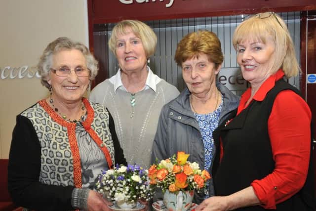 Agnes Wharry, Gladys Smyth, Moira McAllister and Margaret McMullan take a keen interest in some of the flower arrangements on display at the Slemish Area WI AGM. GB1736D18