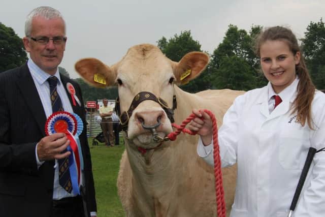 Judge John Henning, Moira, congratulates Victoria Johnston, Clogher, champion junior handler in the cattle section at the 106th Lurgan Show. Picture: Julie Hazelton