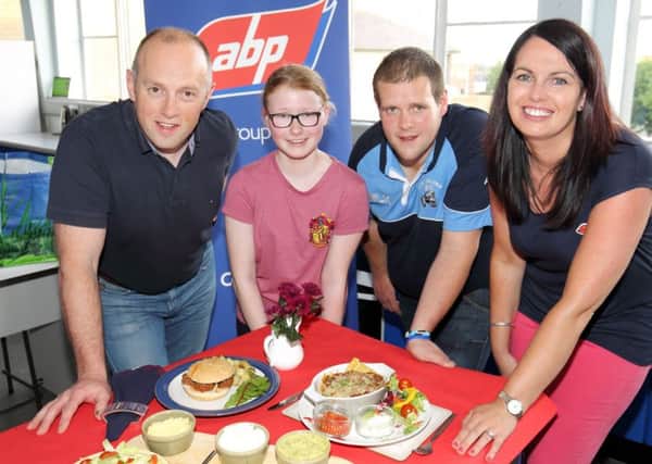 Summer Henderson, from Donaghadee, winner of the junior section of the Co Down YFC's Young Hostess competition, and Andrew Ritchie, from Ballywalter, winner of the senior section, with Philip Simpson, ABP, and home economics teacher at Down High School Sharon McKee