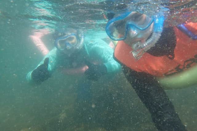 A YFCU member looks for sea life underwater at Groomsport during the Snorkel Safari