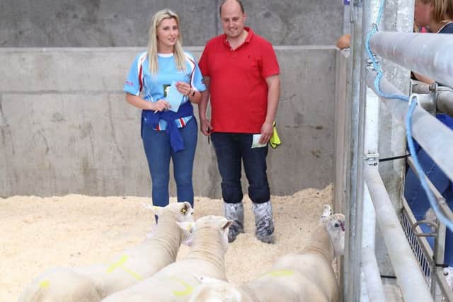 Louise Conn and David Oliver, Dungiven YFC, assess sheep at the stock judging finals