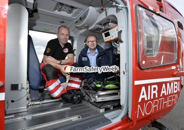 HSENI Chief Executive Keith Morrison with Helicopter Emergency Medical Service Operational leader Glenn ORourke inside an air ambulance at Air Ambulance HQ in the Maze site, Lisburn.