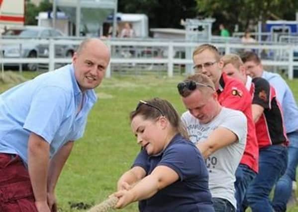 Trillick YFC participating in tug of war with help from Gareth Hamilton, Derg Valley YFC and their coach David Oliver, Dungiven YFC