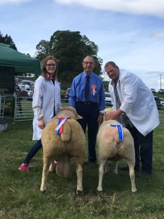 Left to right: Georgina Mulligan with her Ile de France Breed Champion, judge Monsieur Jacques Josselin, France and Reserve Champion with David Dalzell