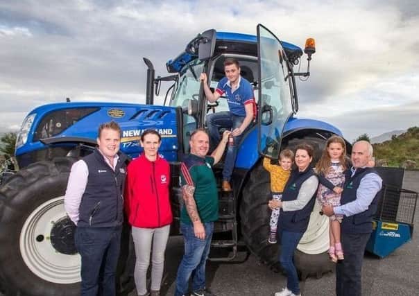Sam Megarity, Collone YFC is pictured picking up the keys to begin the Northern leg of Our Drive to Remember Also pictured is YFCU President James Speers, (left) with Embrace FARM representatives
