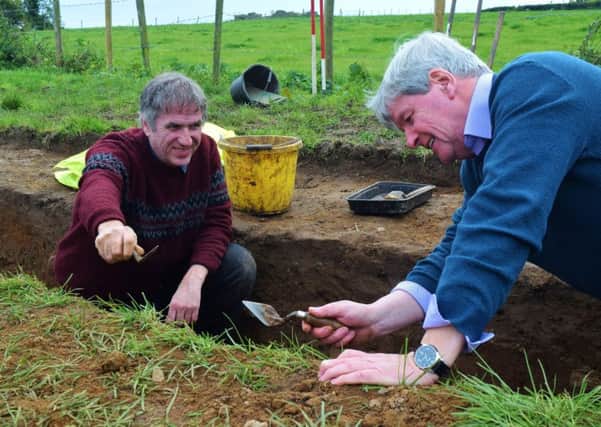 Dr Cormac McSparron gives Joe Mahon a few tips on the use of a trowel at the Ardboe archaeological dig