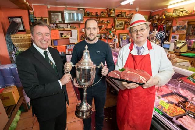 RUAS Chief Executive Alan Crowe with the coveted Allams Cup, along with Keith Williamson, winner of last years Supreme Champion at the Allams Show and Sale and butcher David Moore from Country Meats.