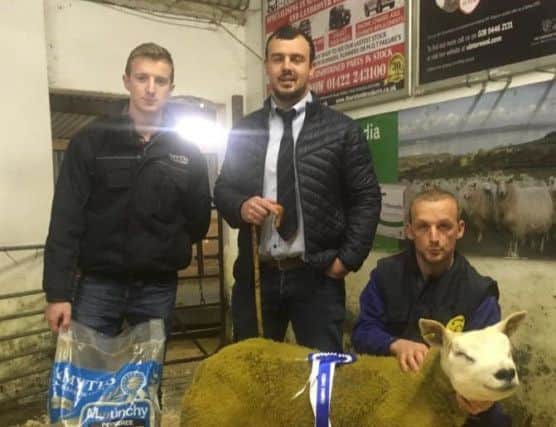 Claiming the Smyths Daleside Reserve Champion Rosette at Gortin Club Show and Sale was Graham and Joanne McFarland, Drewmar Texels, for their ram lamb exhibit.  Pictured handing over the prize was Smyths Daleside representative David Armstrong and judge Cathal Harkin.