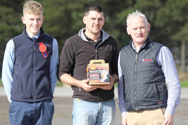 Conrad Fegan, centre, chairman, NI Simmental Cattle Breeders' Club, is pictured at the club's autumn show and sale in Dungannon with Conor Loane, Cookstown, judge; and sponsor Kevin McAnenly, Bimeda. Picture: Julie Hazelton