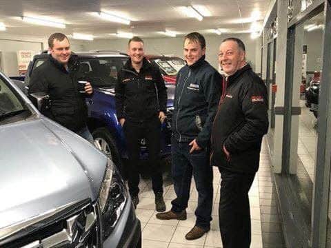 Members James Killen and Gordon Killen with Eakin's salesmen Curtis Nutt and Billy Smith