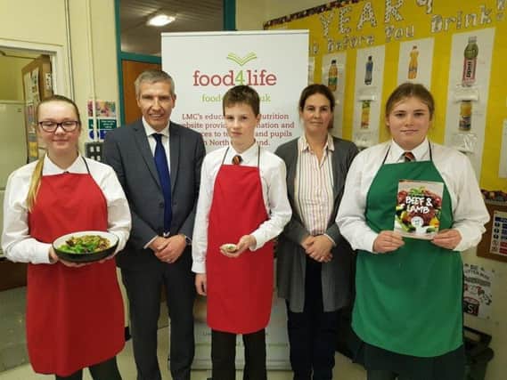 Ian Stevenson, LMC Chief Executive, pictured with Mrs Lisa Donnan, Home Economics teacher and pupils from Friends School, Lisburn during this years launch of LMCs post-primary school cookery demonstrations