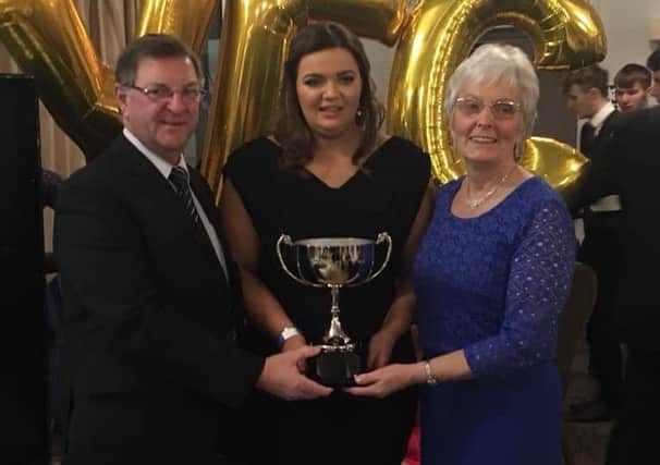 Pictured is Emma Rodgers receiving her award from Allys parents David and Edna Whan for the most inspirational member
