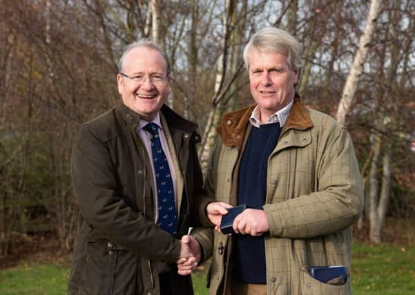 Des Kelly (left) is handed the Hereford Cattle Society's president's badge by outgoing president Jonathan Moorhouse