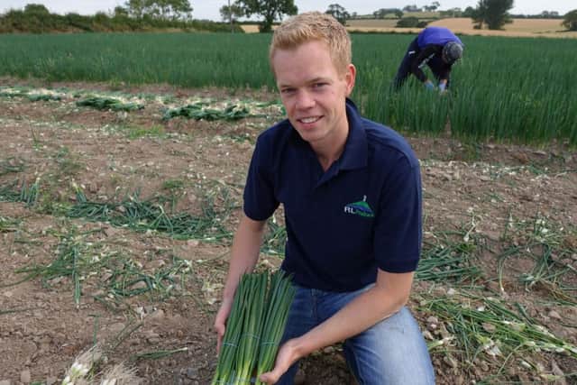 Alex  Lyttle with some of the scallions grown on his Newtownards farm