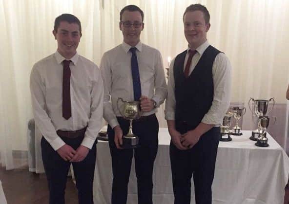 William Beattie presenting Michael Patterson and Jonathan Bristow with The Robert Gault Cup for best senior male
