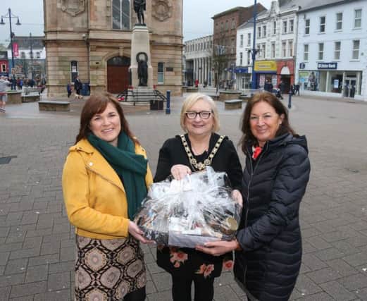 Barbara Millar, who won a hamper full of artisan produce from Causeway Speciality Market after entering a competition in Causeway Coast and Glens Borough Council's first E-zine to registered users of free On-Street WiFi which is available in Ballycastle, Ballymoney, Coleraine, Limavady and Portrush, receives her prize from the Mayor of Causeway Coast and Glens Borough Council Councillor Brenda Chivers and Town & Village Manager Julienne Elliott. PICTURE KEVIN MCAULEY/MCAULEY MULTIMEDIA