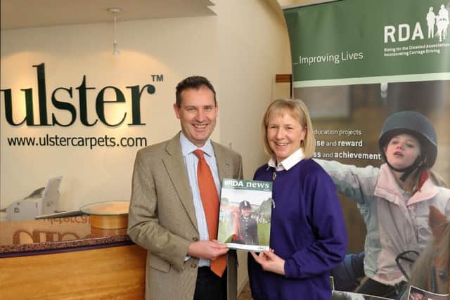 Nick Coburn CBE with past Regional Chairperson, Julie Jordan MBE marking the start Ulster Carpet's sponsorship of the region's magazine