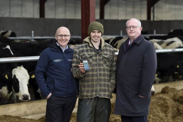 Gerry Hackett, from DAERA, with Dale Farm dairy farmer James Lindsay and Neil McKeown, Neueda. Picture: Michael Cooper