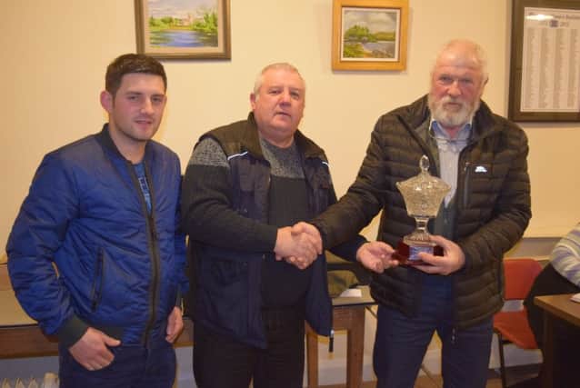 Northern Ireland Sheepdog Handlers Association vice chairman Dean McAuley and chairman Brian Kelly present John Maginn with a cut glass vase to mark his success in 2018 in Brace Competitions.