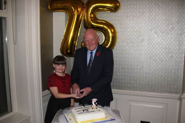 Club patron, Ernest OHara and the youngest member, Annie Gilliland, who cut the cake at the 75th anniversary dinner