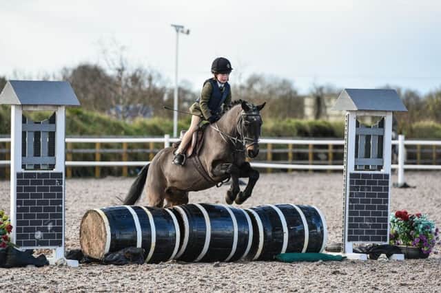 Lily Murphy riding Buzby, winners of the 60cm Working Hunter