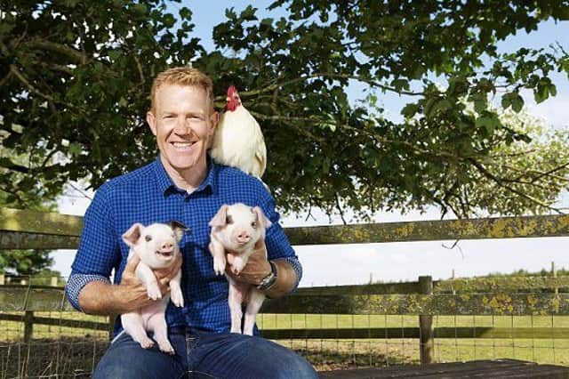 Adam Henson with Gloucestershire Old Spot piglet