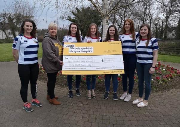 Members presenting a cheque to Cystic Fibrosis