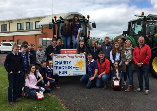 Seskinore Young Farmers' Club pictured in front of the lead tractor that was in aid of Marie Curie and Air Ambulance NI