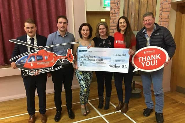 Left to right: James Robson, Steve Hamilton, Laura Patterson, Heather Patterson, Grace Williams from air ambulance NI and Michael Scott,  officials and club president handing cheque over to Air Ambulance NI