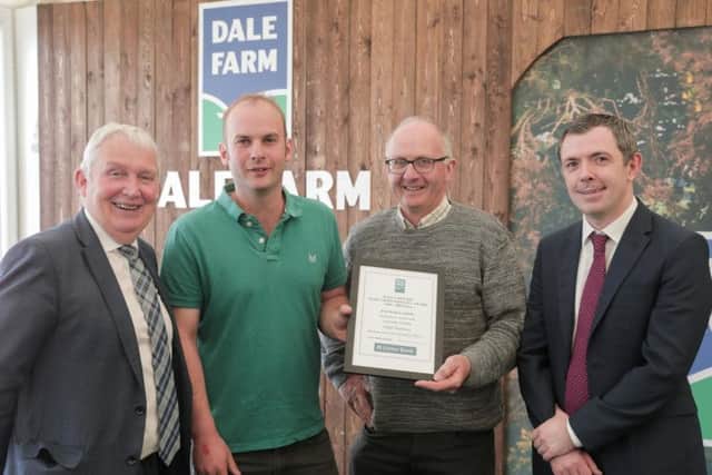 Pictured are Hugh and Thompson Harbison from Aghadowey receiving the 7,000 - 8,000 litre award