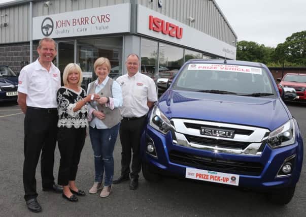 Martine Lafferty from Farming Life presents the keys of the Isuzu pick-up to Gillian McConnell who won the Farming Life Isuzu Prize at Balmoral Show.Looking on is John Barr Dealer Cfrumlin and Alastair Kerr Dealer Relationship Manager Izuzu.PICTURE KEVIN MCAULEY/MCAULEY MULTIMEDIA