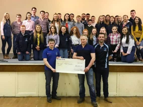 Crumlin YFC members presenting a cheque for 1,000 to charity at their parents night back in April