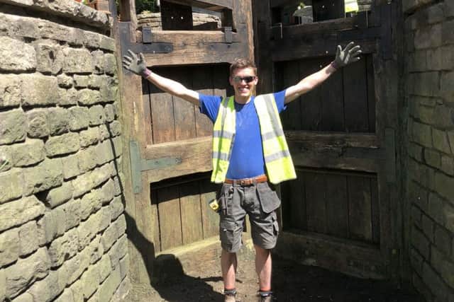 An ecstatic Greenmount Campus student, Reece McKay standing in the the Canal section of the Welcome to Yorkshire Garden showing the Hard Landscaping undertaken by Reece and the Mark Gregory Landform team